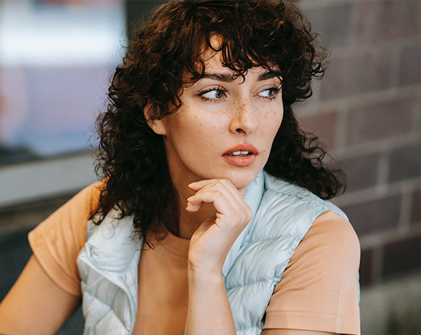 Woman thinking about the difference between urine and blood pregnancy testing